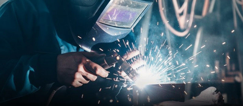 Worker operating a Power Press Machine